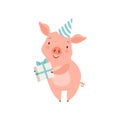 Cute little pig in party hat holding gift box, funny piglet cartoon character vector Illustration on a white background Royalty Free Stock Photo