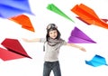 Cute little pilot among colorful paper planes Royalty Free Stock Photo