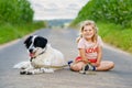 Cute little preschool girl going for a walk with family dog in nature. Happy smiling child having fun with dog, run and Royalty Free Stock Photo