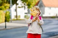 Cute little preschool girl on her first day going to playschool. Healthy happy child walking to nursery school. Kid with Royalty Free Stock Photo