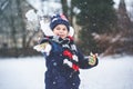 Cute little preschool girl outdoors in winter park . Adorable healthy happy child playing and having fun with snow Royalty Free Stock Photo