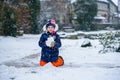 Cute little preschool girl outdoors in winter park . Adorable healthy happy child playing and having fun with snow Royalty Free Stock Photo