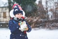 Cute little preschool girl outdoors in winter park . Adorable healthy happy child playing and having fun with snow Royalty Free Stock Photo