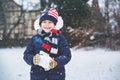 Cute little preschool girl outdoors in winter park . Adorable healthy happy child playing and having fun with snow Royalty Free Stock Photo