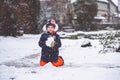 Cute little preschool girl outdoors in winter park . Adorable healthy happy child playing and having fun with snow Royalty Free Stock Photo