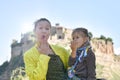 Cute little preschool girl and young mother looking at camera blowing a kiss. Mom and daughter traveling together in a beautiful