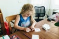 Cute little preschooler child drawing at home