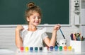 Cute little preschooler child girl drawing at school. Child girl painting on elementary school. Kids creative growth. Royalty Free Stock Photo