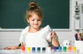 Cute little preschooler child girl drawing at school. Child girl painting on elementary school. Little funny artist