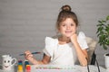 Cute little preschooler child girl drawing at school. Child girl painting on elementary school. Funny kids face. Royalty Free Stock Photo