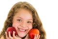 Cute little preschooler girl holding two peaches