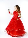 Cute little princess dressed in red isolated on white background