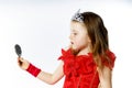 Cute little princess dressed in red on white background