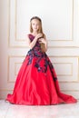 Cute little redhead girl wearing an antique princess dress or costume. Royalty Free Stock Photo