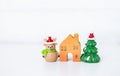 Cute little reindeer doll and wooden house with Christmas tree on white background, decoration item Royalty Free Stock Photo