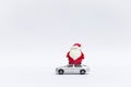 Cute little Santa claus doll on model car isolate on white background Royalty Free Stock Photo