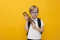 Cute little school boy in glasses holding abacus on yellow background. Mental arithmetic Royalty Free Stock Photo