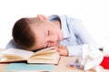 Cute little school boy with huge smile sitting at his desk on white background. Happy intelligent children in shirt with blue eye Royalty Free Stock Photo