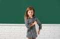 Cute little school kid girl study in a classroom. Education, learning and children concept. Royalty Free Stock Photo
