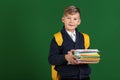 Cute little schoolboy with backpack and stationery on color background Royalty Free Stock Photo