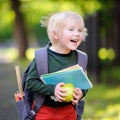Cute little schoolboy with his backpack and apple. Back to school concept. Royalty Free Stock Photo