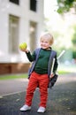 Cute little schoolboy with his backpack and apple. Back to school concept. Royalty Free Stock Photo
