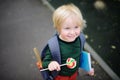 Cute little schoolboy with his backpack and lollipop. Back to school concept. Royalty Free Stock Photo