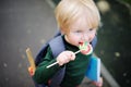 Cute little schoolboy with his backpack and lollipop. Back to school concept. Royalty Free Stock Photo