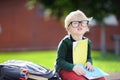 Cute little schoolboy studying outdoors on sunny day. Back to school concept. Royalty Free Stock Photo