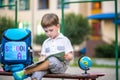 Cute little schoolboy studying outdoors on sunny day Royalty Free Stock Photo