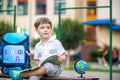 Cute little schoolboy studying outdoors on sunny day Royalty Free Stock Photo