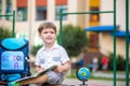 Cute little schoolboy studying outdoors on sunny day Royalty Free Stock Photo