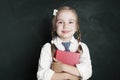 Cute little schoolgirl child with school book