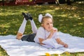 Cute little schoolgirl doing homework in a sunny autumn park. Outdoor education for children. Back to school concept Royalty Free Stock Photo