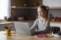 Cute Little Schoolgirl Study With Laptop At Home, Typing On Computer Keyboard Royalty Free Stock Photo