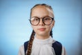 Cute Little Schoolgirl Wearing Glasses On Blue Backround Royalty Free Stock Photo