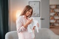 Cute little shirt. Beautiful pregnant woman is indoors at home