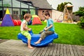 Cute little siblings swinging Royalty Free Stock Photo