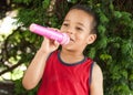 Cute little singer boy singing on the microphone in the city par