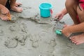 Cute little sisters playing with sand on the beach on summer holidays. Children building a sandcastle at sea. Travelling with kids