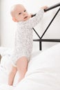 Child`s first attempts to stand up. Royalty Free Stock Photo