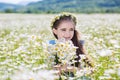 Cute little smiling girl in the chamomile field Royalty Free Stock Photo