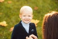 Cute little smiling happy boy in suit. Portrait of kid outdoors. Close-up face child playing outdoors in summer park. Royalty Free Stock Photo