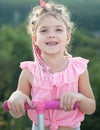Cute little smiling happy girl close up face. Lifestyle closeup portrait of funny kids face outdoors. Summer kid outdoor Royalty Free Stock Photo