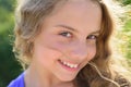 Cute little smiling happy girl close up face. Portrait of kid outdoors. Close-up face child playing outdoors in summer Royalty Free Stock Photo