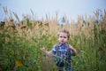 Cute little stands in the middle of the field is high . Memories childhood and carefree