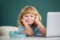 Cute little student boy using laptop computer in school class. Royalty Free Stock Photo