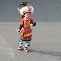 Cute little Taiwanese girl in garb of Amis Tribe from Hualien Matain with headdress and skirt, Kaohsiung, Taiwan