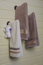 Three towels are hanging on a wooden wall Royalty Free Stock Photo