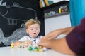 Cute little toddler boy at child therapy session.